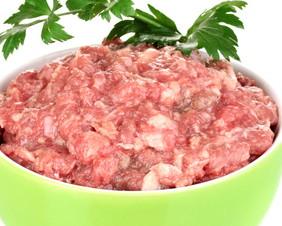 Bowl of raw ground meat isolated on white